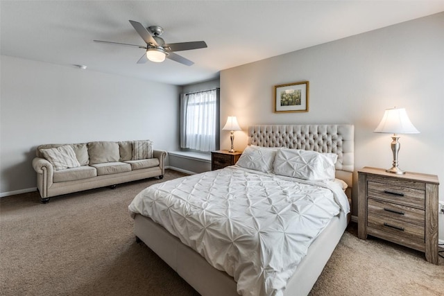 bedroom featuring light colored carpet, a ceiling fan, and baseboards