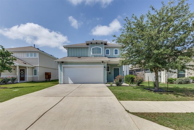 view of front of property featuring board and batten siding, driveway, an attached garage, and a front yard