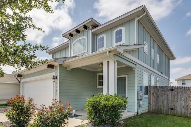 view of front of home featuring board and batten siding and fence