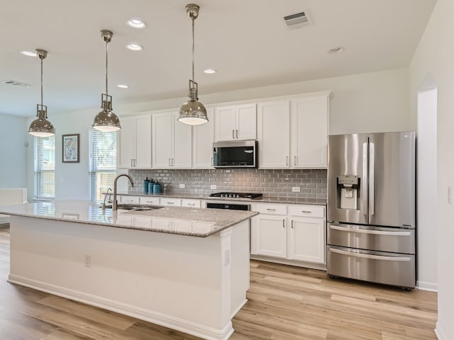 4325 Arques Ave, Round Rock, TX 78681 - kitchen featuring stainless steel appliances, a sink, white cabinetry, light wood finished floors, and recessed lighting