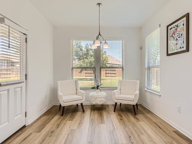4325 Arques Ave, Round Rock, TX 78681 - living area with a chandelier, light wood-style flooring, and baseboards
