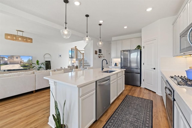 424 Turnbuckle Bnd, Leander, TX 78641 - kitchen featuring appliances with stainless steel finishes, a sink, decorative backsplash, light countertops, and recessed lighting