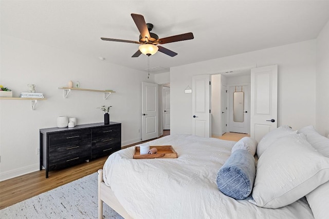 424 Turnbuckle Bnd, Leander, TX 78641 - bedroom with light wood-type flooring, baseboards, and a ceiling fan