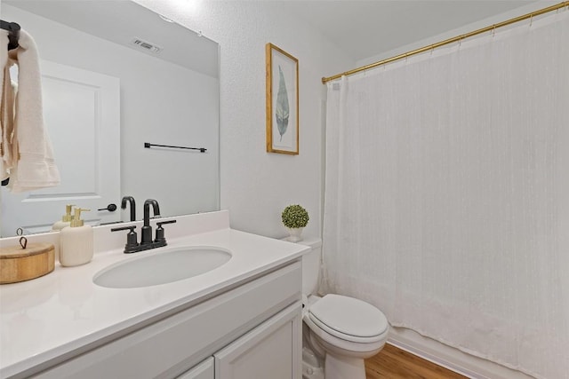 424 Turnbuckle Bnd, Leander, TX 78641 - full bathroom featuring vanity, toilet, and wood finished floors