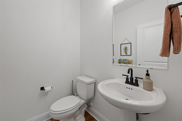 424 Turnbuckle Bnd, Leander, TX 78641 - bathroom with a sink, toilet, and baseboards