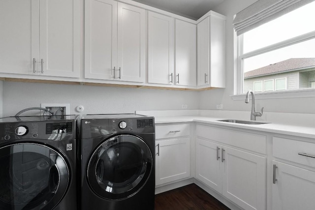 16616 Sumptuous Dr, Manor, TX 78653 - laundry room featuring washing machine and clothes dryer, cabinet space, and dark wood-type flooring