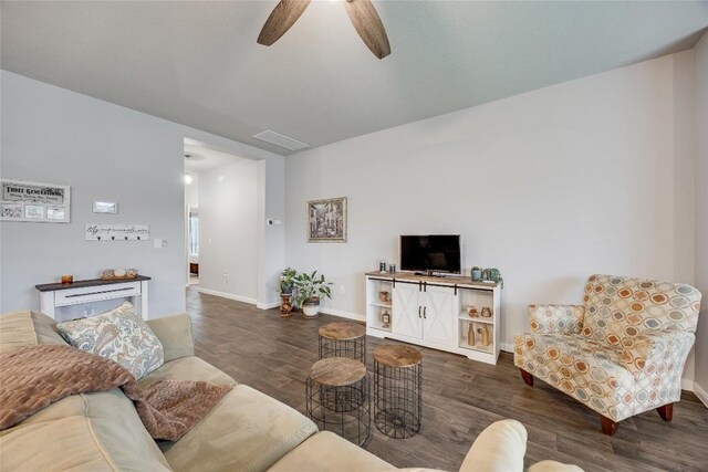 living room featuring wood finished floors, baseboards, and a ceiling fan