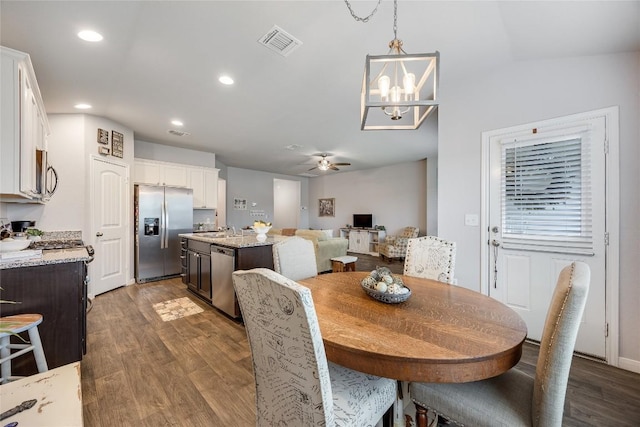 100 Seaholm Ln, Hutto, TX 78634 - dining room featuring a chandelier, wood finished floors, a ceiling fan, and recessed lighting
