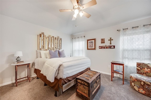 carpeted bedroom featuring baseboards and a ceiling fan