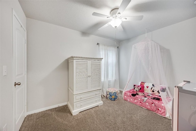 bedroom featuring carpet floors, baseboards, ceiling fan, and a textured ceiling