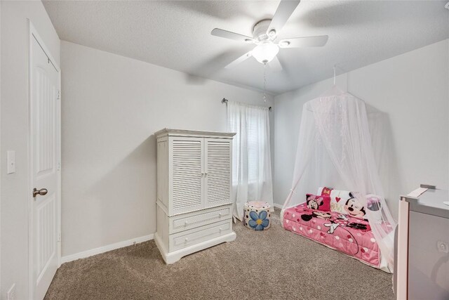 100 Seaholm Ln, Hutto, TX 78634 - carpeted bedroom featuring a ceiling fan and a textured ceiling