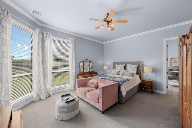 carpeted bedroom featuring ornamental molding, ceiling fan, and baseboards