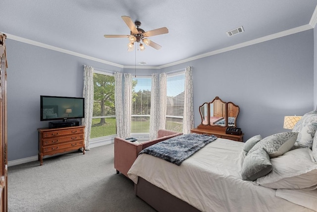 carpeted bedroom with ornamental molding, ceiling fan, and baseboards