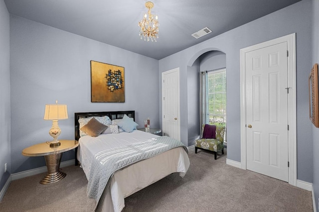 bedroom with carpet, arched walkways, a chandelier, and baseboards
