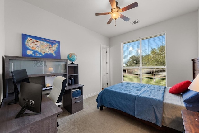 carpeted bedroom featuring an office area, baseboards, and a ceiling fan