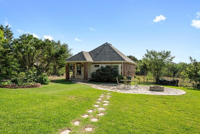rear view of property featuring an outdoor fire pit, a patio area, and brick siding