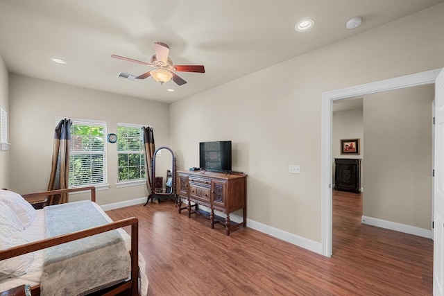 bedroom featuring wood finished floors, baseboards, recessed lighting, and ceiling fan