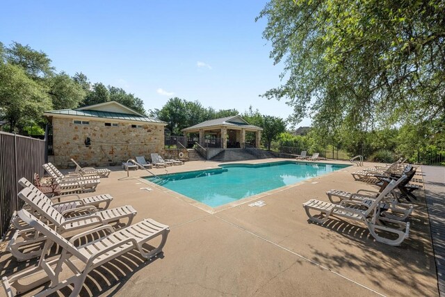 117 Hucks Hideaway, Dripping Springs, TX 78620 - community pool featuring a gazebo, a patio, and view of wooded area