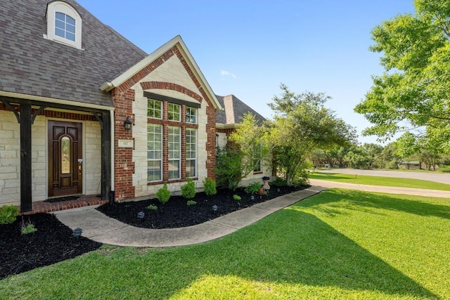 117 Hucks Hideaway, Dripping Springs, TX 78620 - doorway to property with roof with shingles, a yard, and brick siding