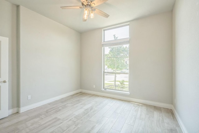 empty room with light wood-style flooring, baseboards, and ceiling fan