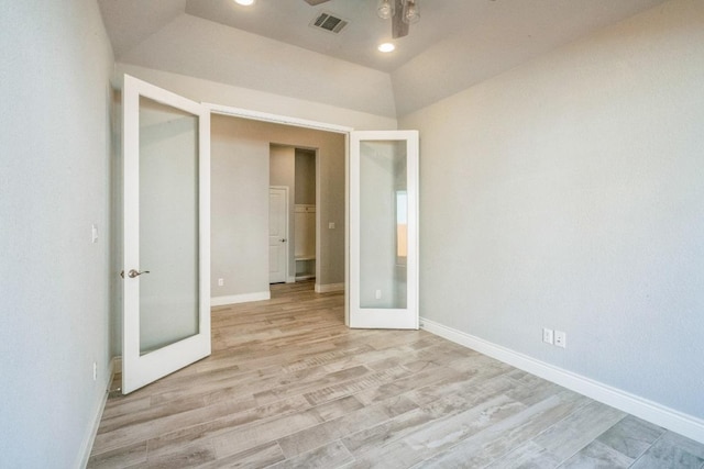 unfurnished bedroom with french doors, wood finished floors, baseboards, and recessed lighting