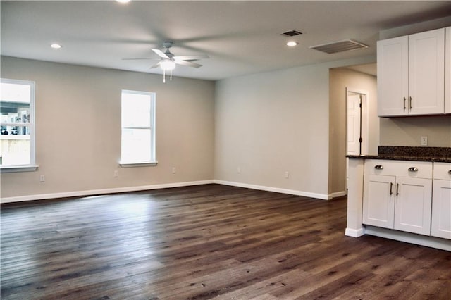 406 Rivers St, Smithville, TX 78957 - unfurnished living room with a ceiling fan, dark wood-type flooring, baseboards, and recessed lighting