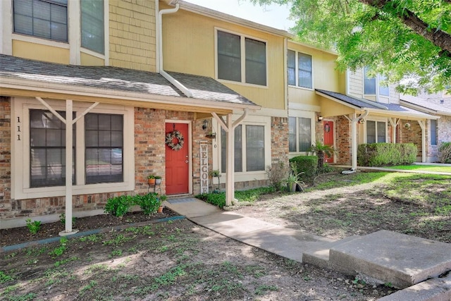 11901 Swearingen Dr Unit 110, Austin, TX 78758 - view of property featuring brick siding, stone siding, and roof with shingles