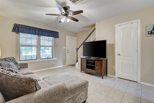 11901 Swearingen Dr Unit 110, Austin, TX 78758 - living room featuring light tile patterned floors, ceiling fan, and stairway