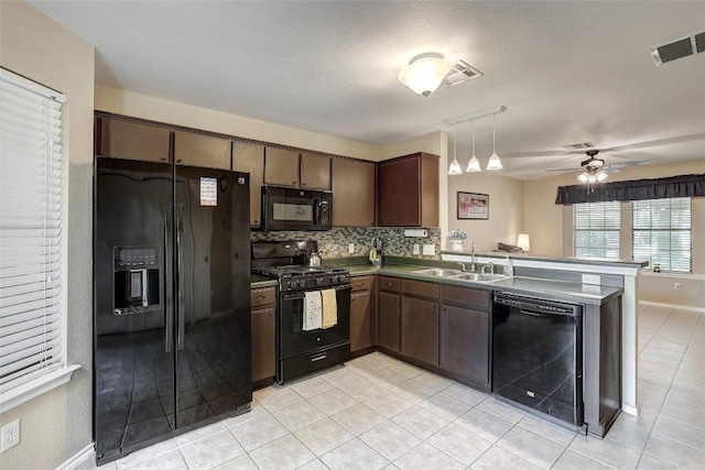 11901 Swearingen Dr Unit 110, Austin, TX 78758 - kitchen featuring black appliances, a peninsula, decorative backsplash, light tile patterned floors, and a textured ceiling