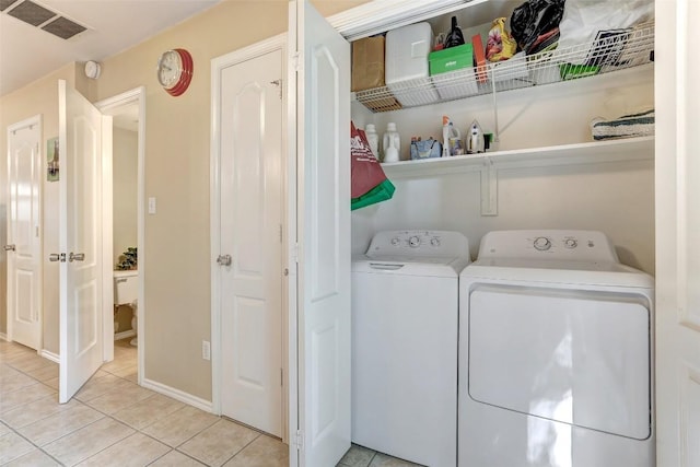 11901 Swearingen Dr Unit 110, Austin, TX 78758 - laundry area featuring washer and dryer and light tile patterned floors
