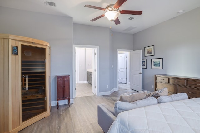 3405 Eagle Ridge Ln, Pflugerville, TX 78660 - bedroom with light wood-type flooring, a sauna, a spacious closet, baseboards, and ensuite bathroom