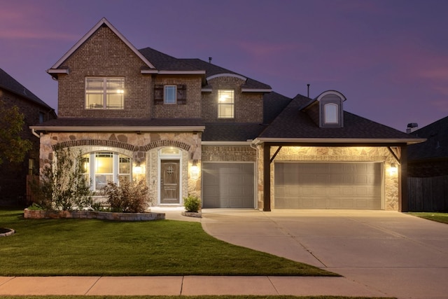3405 Eagle Ridge Ln, Pflugerville, TX 78660 - view of front facade with concrete driveway, a front lawn, stone siding, and brick siding