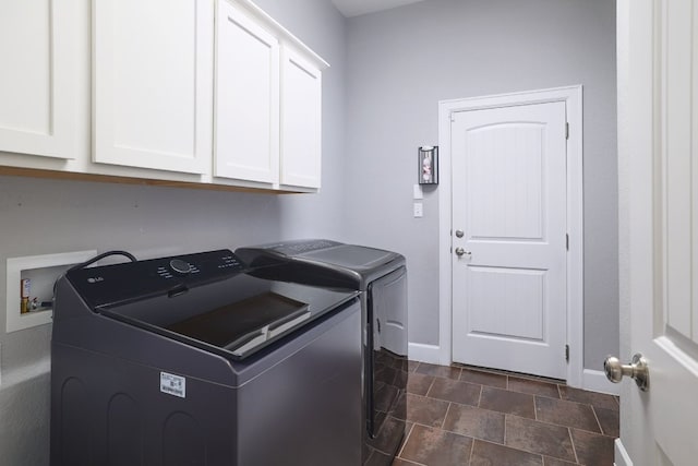 3405 Eagle Ridge Ln, Pflugerville, TX 78660 - washroom featuring cabinet space, washing machine and clothes dryer, baseboards, and stone finish flooring