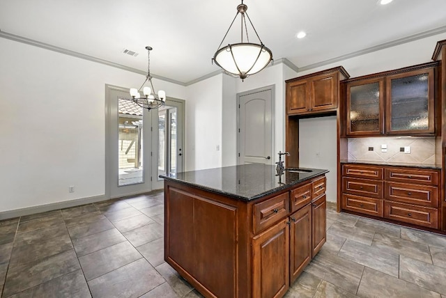 101 Blanco Ct, Horseshoe Bay, TX 78657 - kitchen featuring a sink, dark stone counters, ornamental molding, decorative backsplash, and glass insert cabinets