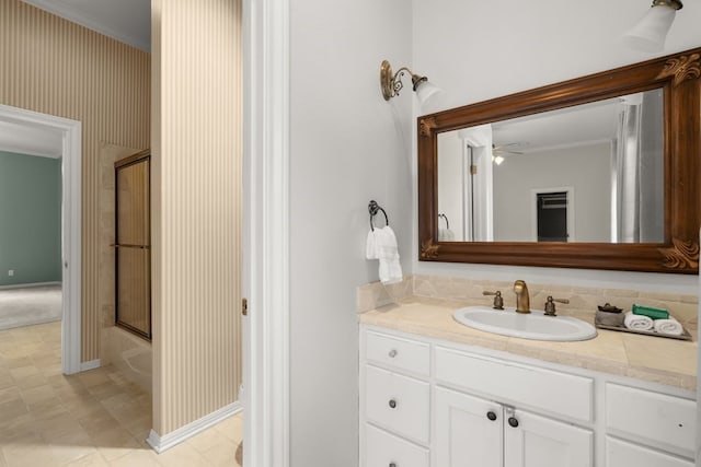 112 Oak Ct, Bastrop, TX 78602 - full bath with vanity, ornamental molding, bath / shower combo with glass door, and baseboards