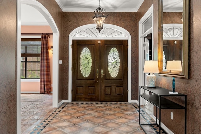 112 Oak Ct, Bastrop, TX 78602 - foyer featuring healthy amount of natural light, arched walkways, baseboards, wallpapered walls, and ornamental molding