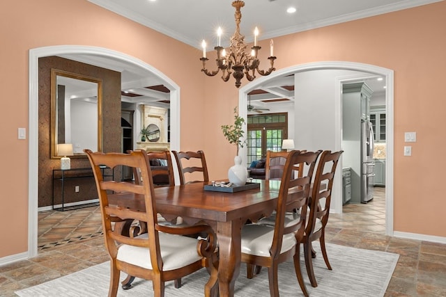 112 Oak Ct, Bastrop, TX 78602 - dining space with arched walkways, stone tile floors, ornamental molding, baseboards, and a chandelier
