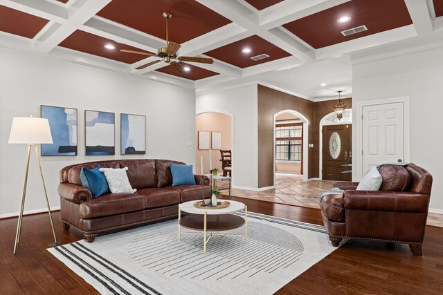 112 Oak Ct, Bastrop, TX 78602 - living room featuring arched walkways, ceiling fan, wood-type flooring, coffered ceiling, and baseboards