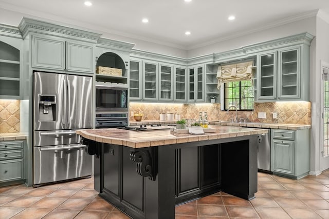 112 Oak Ct, Bastrop, TX 78602 - kitchen with black appliances, open shelves, tile counters, ornamental molding, and a sink