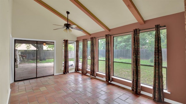 unfurnished sunroom featuring beam ceiling, baseboards, and high vaulted ceiling