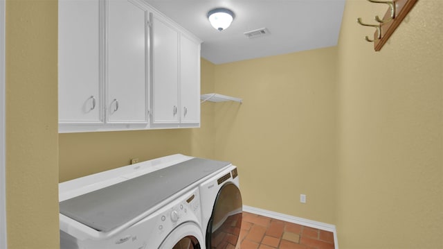 clothes washing area featuring baseboards, cabinet space, and separate washer and dryer
