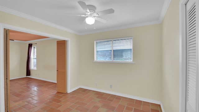 spare room featuring healthy amount of natural light, baseboards, crown molding, and ceiling fan
