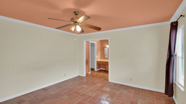 spare room with ceiling fan, baseboards, ornamental molding, and brick floors