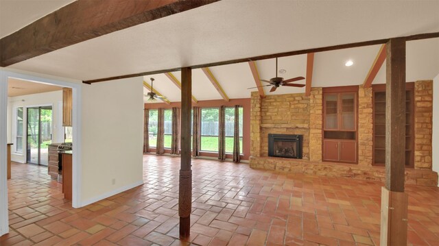 unfurnished living room with a ceiling fan, plenty of natural light, a stone fireplace, and recessed lighting