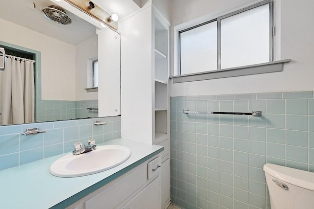 3305 Carol Ann Dr, Austin, TX 78723 - full bathroom featuring tile walls, vanity, and toilet