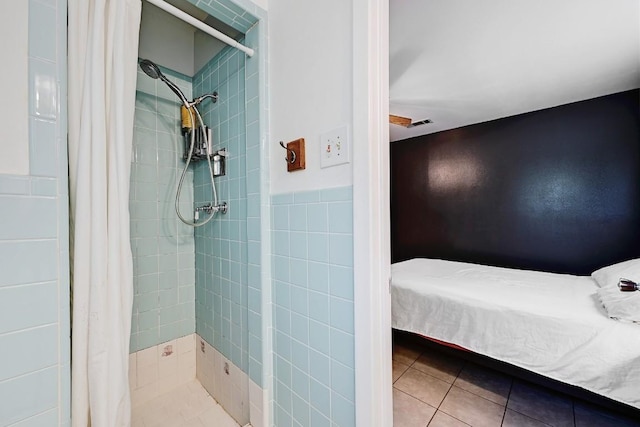 3305 Carol Ann Dr, Austin, TX 78723 - full bathroom with tile patterned flooring, a tile shower, and tile walls