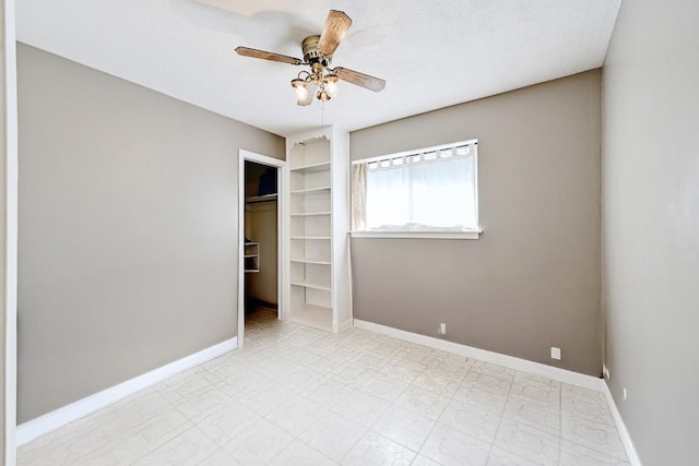 3305 Carol Ann Dr, Austin, TX 78723 - unfurnished bedroom with baseboards, a walk in closet, a ceiling fan, and a closet