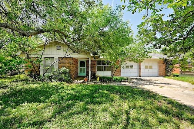 3305 Carol Ann Dr, Austin, TX 78723 - view of front of property with brick siding, an attached garage, and concrete driveway