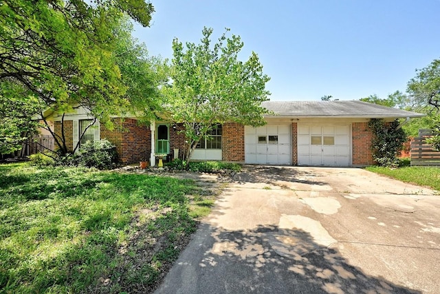 3305 Carol Ann Dr, Austin, TX 78723 - view of front of property featuring brick siding, an attached garage, and concrete driveway