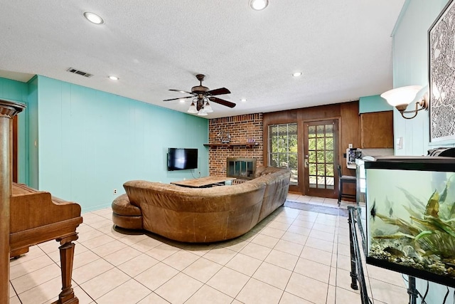 3305 Carol Ann Dr, Austin, TX 78723 - living room with a brick fireplace, a ceiling fan, recessed lighting, light tile patterned floors, and a textured ceiling